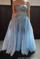 Front view of light blue strapless ball gown on model