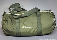 Front view showing Champion script logo, handles and strap