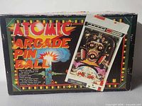 Front of original Tomy Atomic Arcade Pinball box with graphics