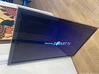 Front of TV displaying Samsung Smart TV startup screen