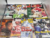 Overhead shot of all eight Sports Illustrated football magazines laid out in two rows
