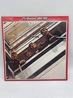 Front cover with red border and upward shot of Beatles