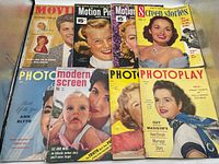 Seven movie magazines laid out showing full covers