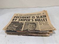 Stack of newspapers with top issue Sacramento Bee JFK assassination headline