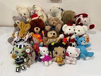 Group shot of entire assortment showing variety of teddy bears, character and holiday-themed plush