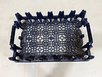 Top view showing lattice bottom and slotted sides of blue plastic carrier