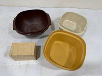 Overview of all items: three plastic Tupperware pieces and wooden recipe card box