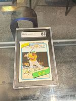 Front of SGC-slabbed 1980 Topps #482 Rickey Henderson rookie card showing grade 8 label