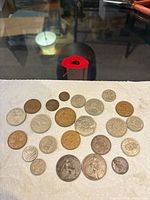 Full layout of ~24 mixed coins on paper towel