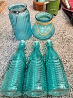 All five aqua/teal glass pieces grouped together