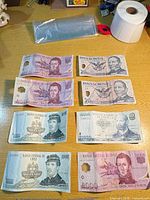 Eight banknotes arranged in four rows showing obverses