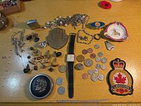 Full layout of all jewellery, coins, collectibles on table