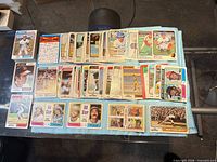 Wide view of entire spread of vintage Topps baseball cards laid out on cloth