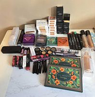Overall view of entire lot showing boxed palettes, lip products, complexion items