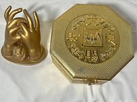 Sculpture and box side by side