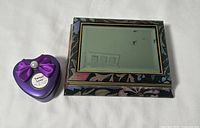 Rectangular mirrored box and purple heart box closed, top view