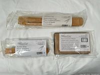 Front view of three sealed Pampered Chef items showing product labels