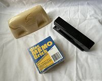 Paperweight, stapler and memo brick on white background