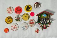 Front view showing cuckoo clock, mouse figurine, and array of vintage buttons