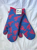 Pair of blue oven mitts with red lobster print