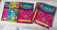Front covers of seven Sudoku Collection books