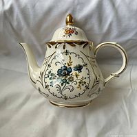 Front view of floral ceramic teapot with lid attached