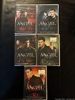 Front covers of five sealed Angel DVD box sets