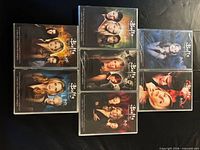 Front covers of all seven sealed Buffy DVD season sets displayed
