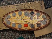 Oval holder showing all 12 Millennium quarters