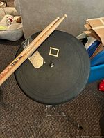 practice pad on stand with drumsticks resting