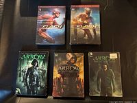 Front covers of all five DVD box sets displayed on table