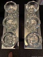 Top view of both mirrored candle holders showing six faceted tealight cups and mirrored bases