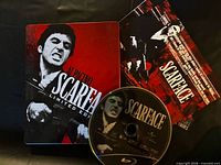 Front of tin case, Scarface artwork, disc, collector cards