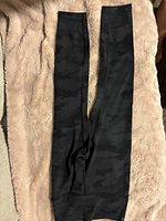 Full view of leggings laid flat showing camouflage pattern