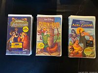 Front covers of the three sealed Disney VHS tapes