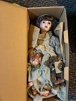 Doll in box showing outfit and accessories