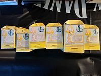 Front view of six yellow Precious Moments boxes labeled Two Year Old through Seven Year Old