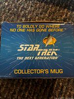 Box top with Star Trek The Next Generation logo and collector’s mug text