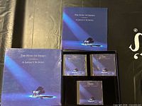 Closed slipcase showing booklet and three jewel cases in insert