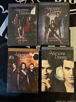 Front view of all four sealed DVD sets: seasons 4–7