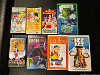 Front covers of all eight VHS tapes displayed