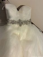 Front view showing sweetheart neckline, beaded waistband, tulle skirt
