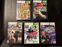 Front view of five Xbox 360 Kinect game cases