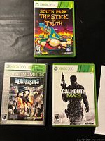 Front covers of Call of Duty MW3, South Park Stick of Truth, Dead Rising Platinum Hits