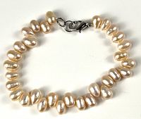 Full view of pearl bracelet laid flat showing all pearls and clasp