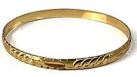 Full view of gold-tone engraved bangle bracelet