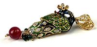 Full side view of pendant showing peacock design, enamel colours, rhinestones and bead drop