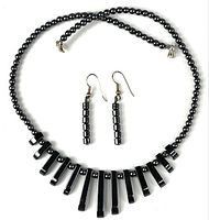 Full view necklace laid circular with earrings centered