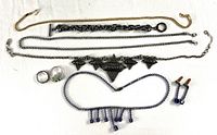All items laid out: five necklaces, bracelet, two rings, earrings