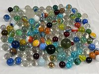 Full group of mixed glass marbles spread on white background